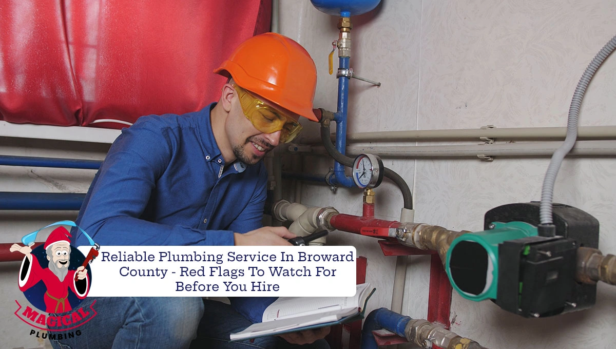 plumber wearing a hardhat and goggles working on pipes