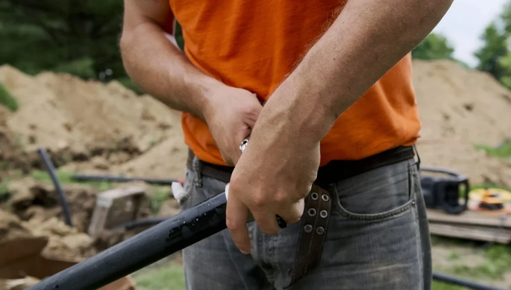 man fixing a broken pipe